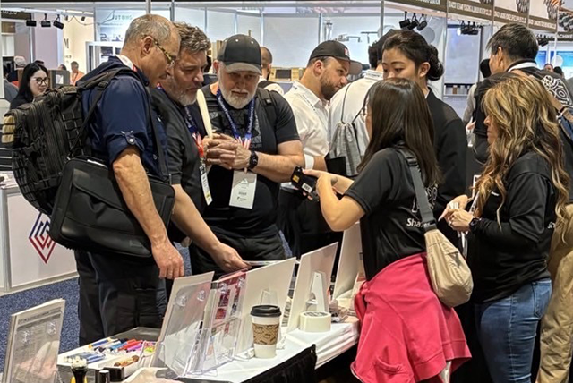 Visitors engaging with the Artline & Xstamper booth, exploring product features through demonstrations and discussions.