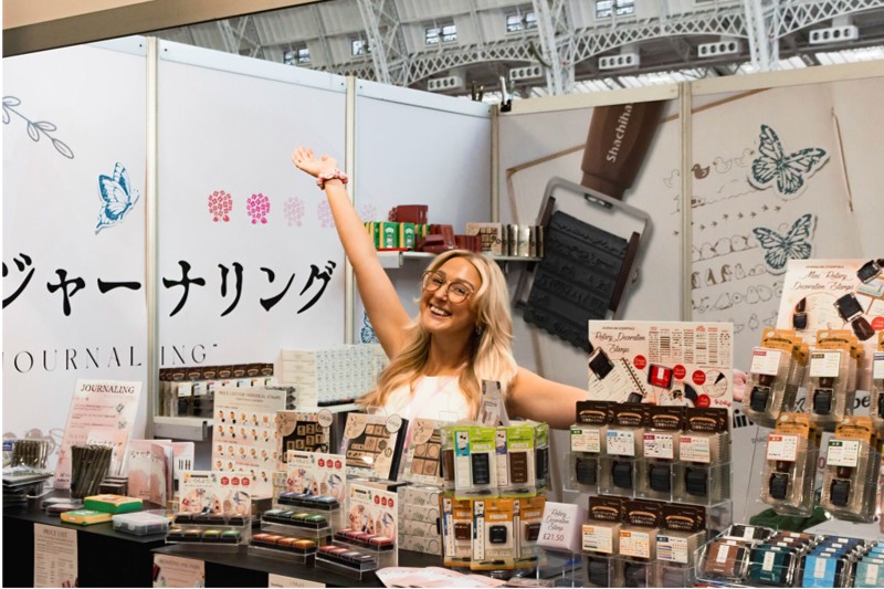 SHEU's exhibition booth and on-site staff.
