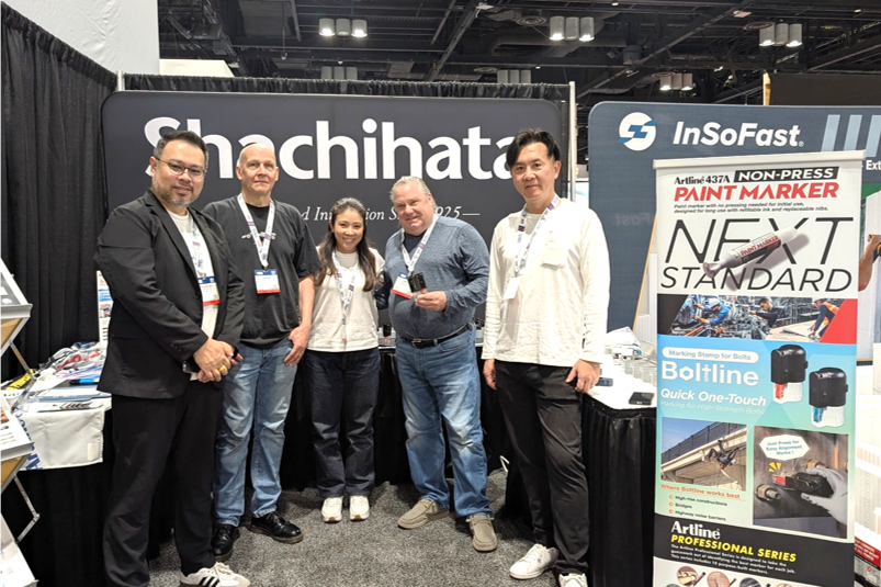 Group photo of Shachihata Inc. (U.S.A.) and head office staff in front of the Shachihata booth at IBS 2026