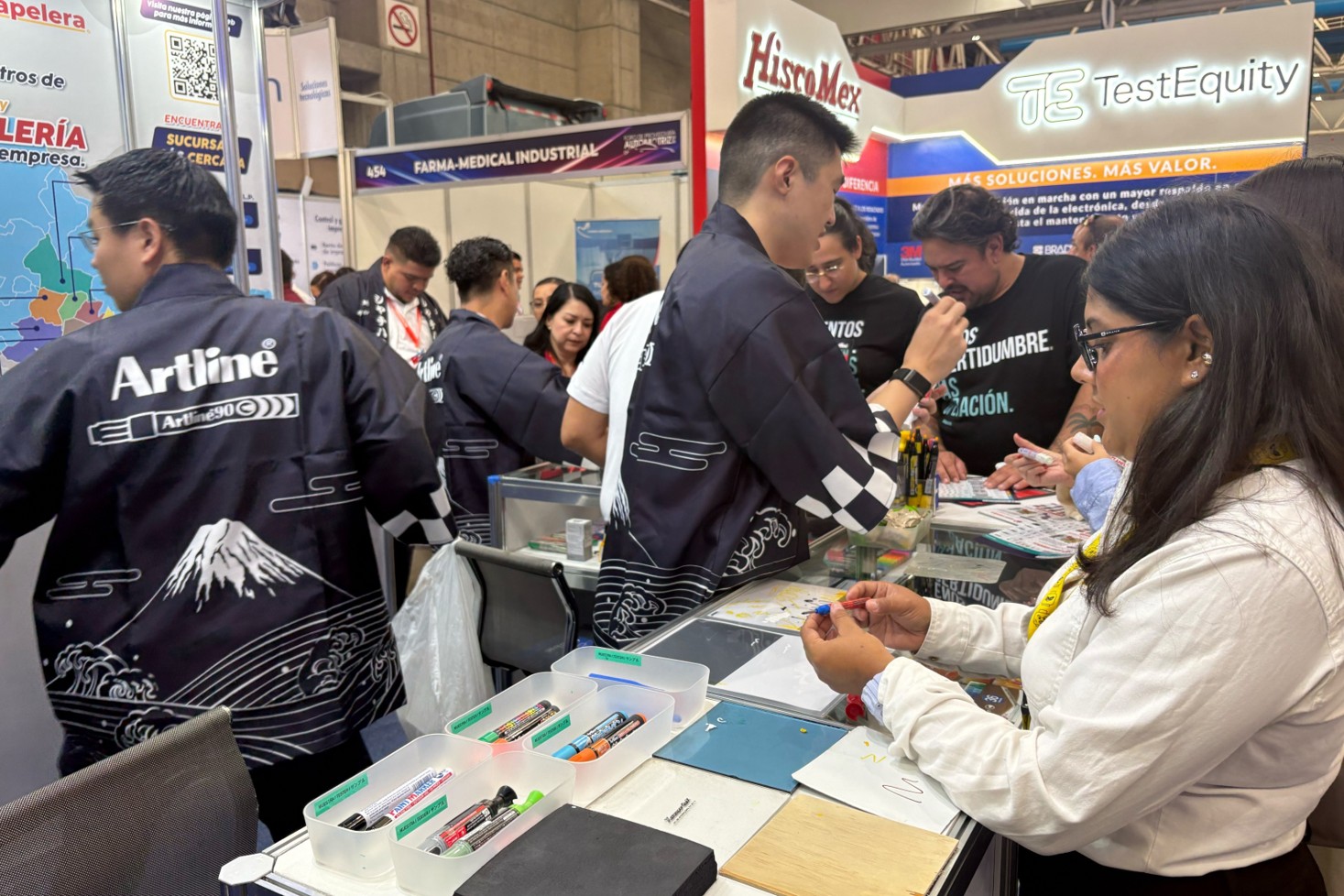 A scene of people looking at the products displayed in the booth.