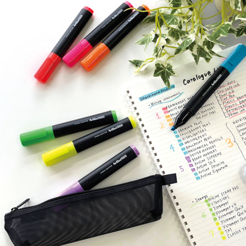 Artline 660 highlighters are on desk with a notebook