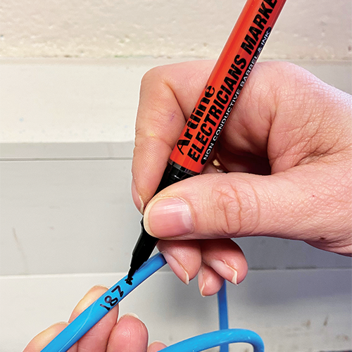 Writing on a blue cable with the ELECTRICIANS MARKER.